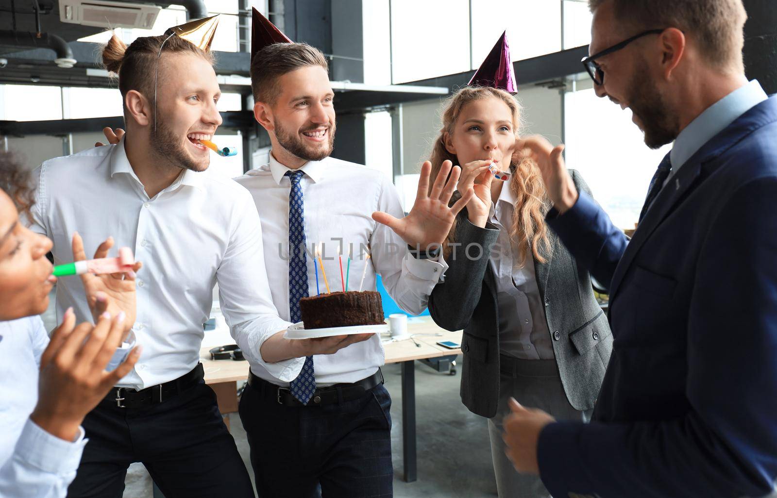 Business team celebrating a birthday of collegue in the modern office.