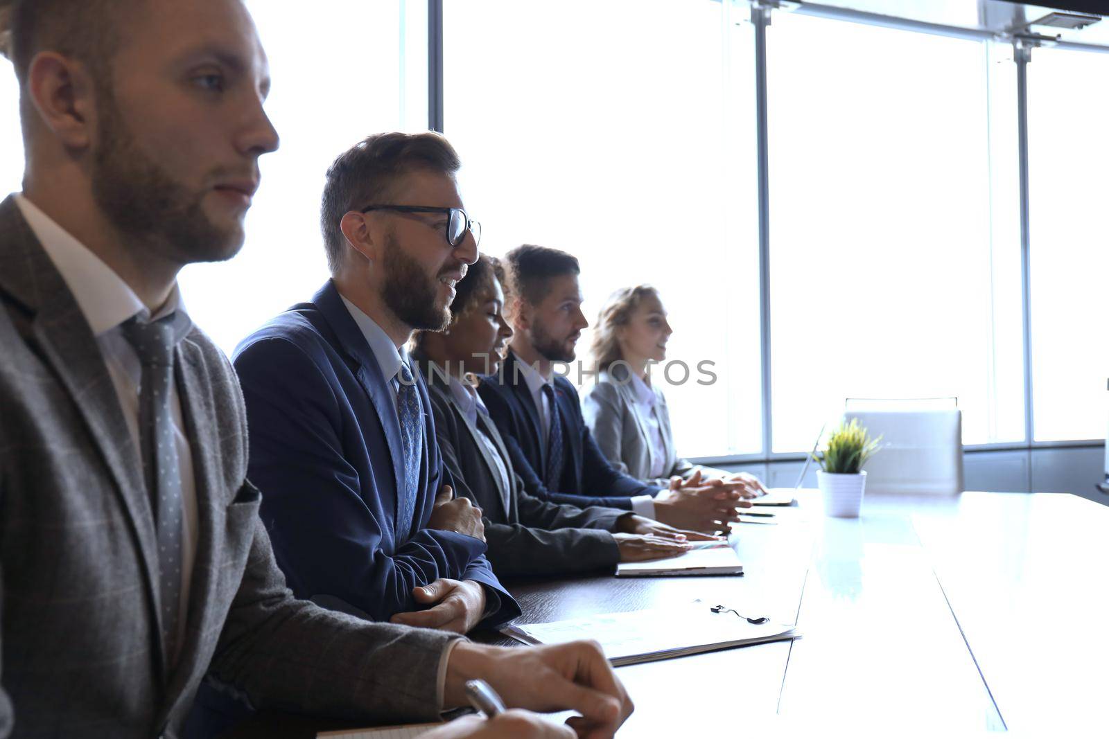 Image of row of business people working at seminar