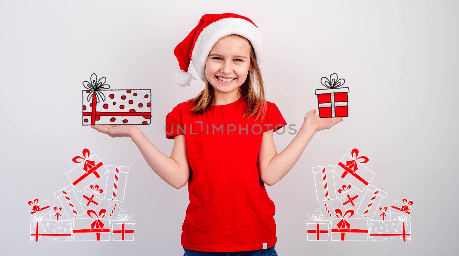 Little girl in santa hat holding christmas presents sketch on white wall background