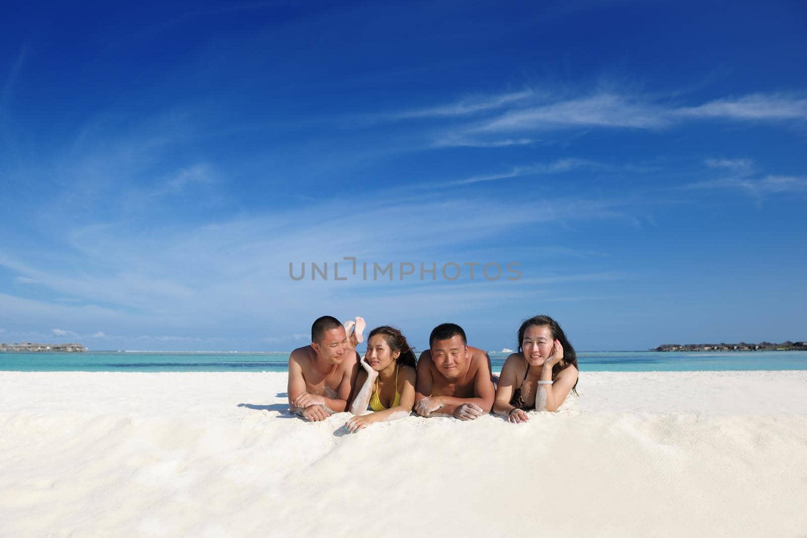 happy young  couple enjoying summer on beach by dotshock