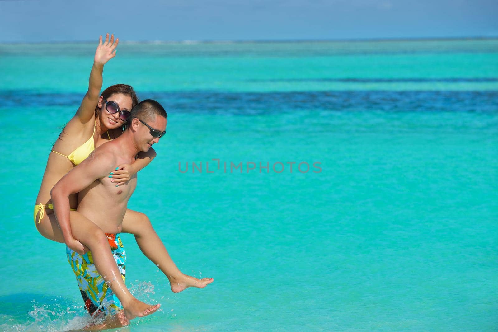 happy young asian couple have fun and romantic time at  summer on beautiful white sand beach