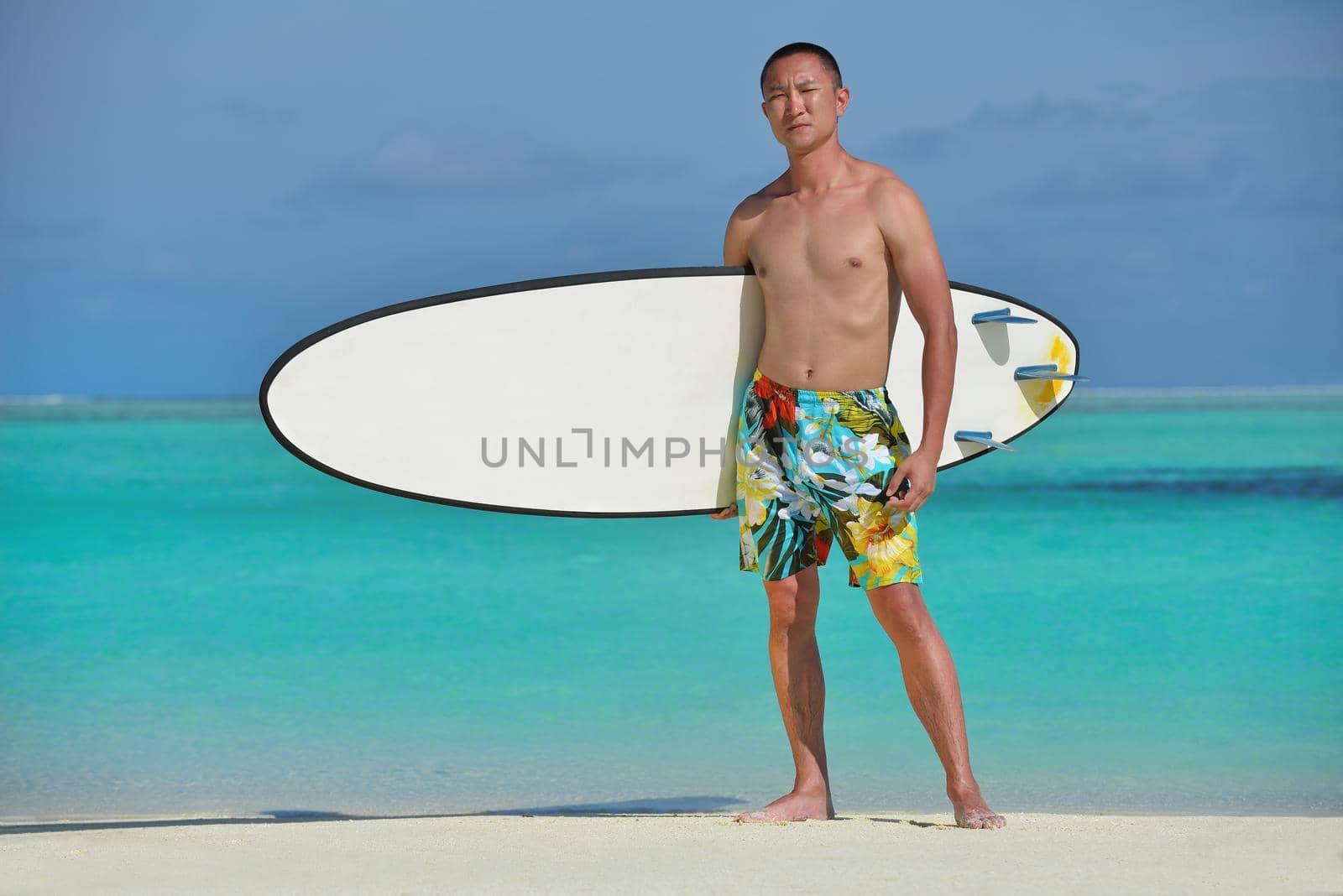 Man with surf board on beautiful tropical beach  beach