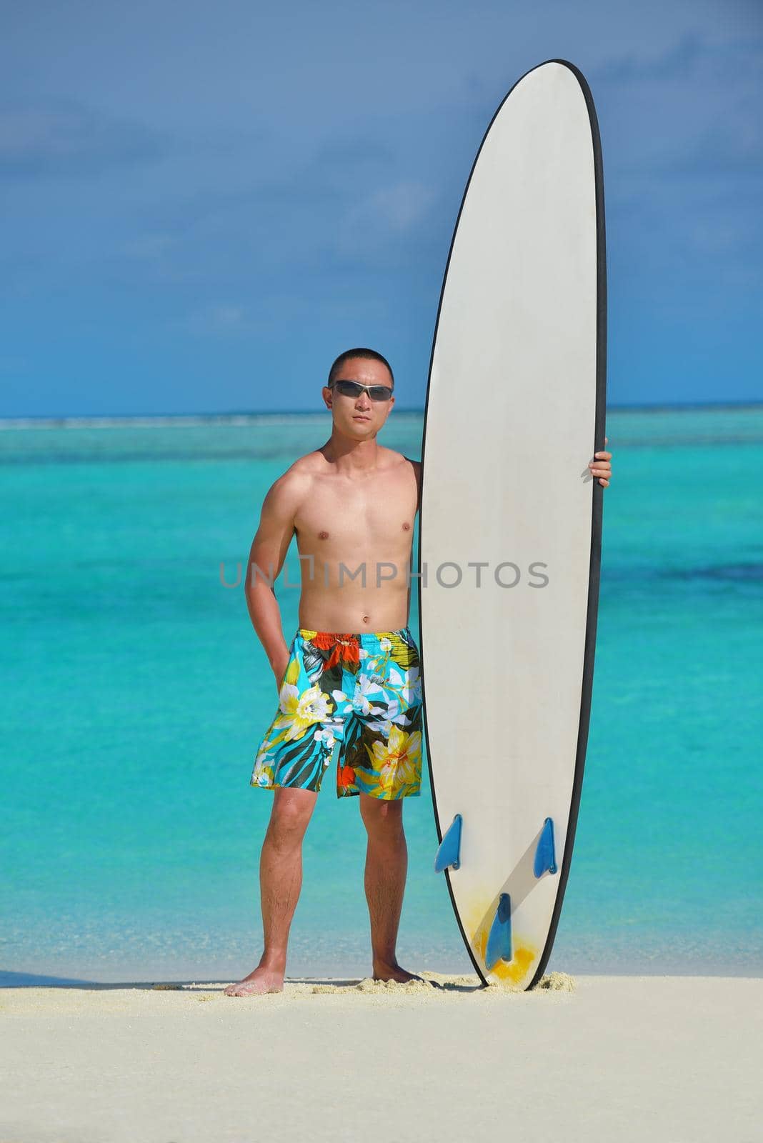 Man with surf board on beautiful tropical beach  beach