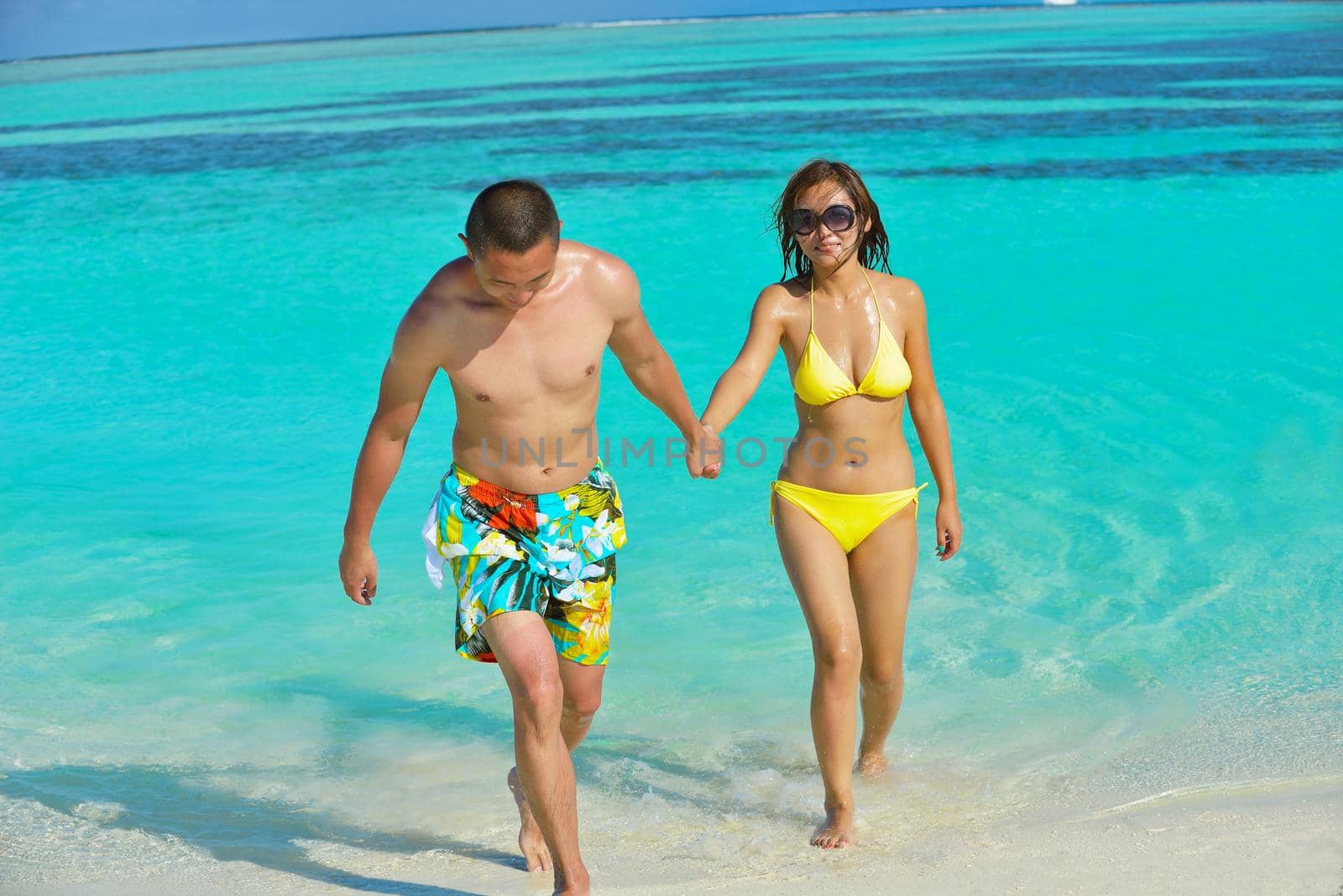 happy young asian couple have fun and romantic time at  summer on beautiful white sand beach