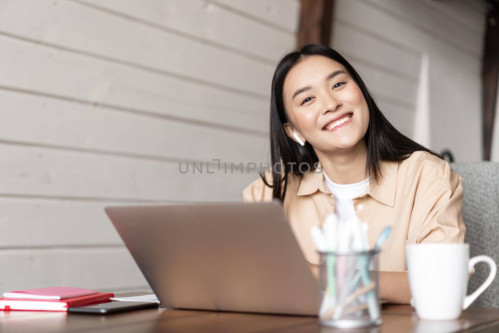 Cute asian girl using laptop, student studying or having online lecure, e-learning and distance education concept.