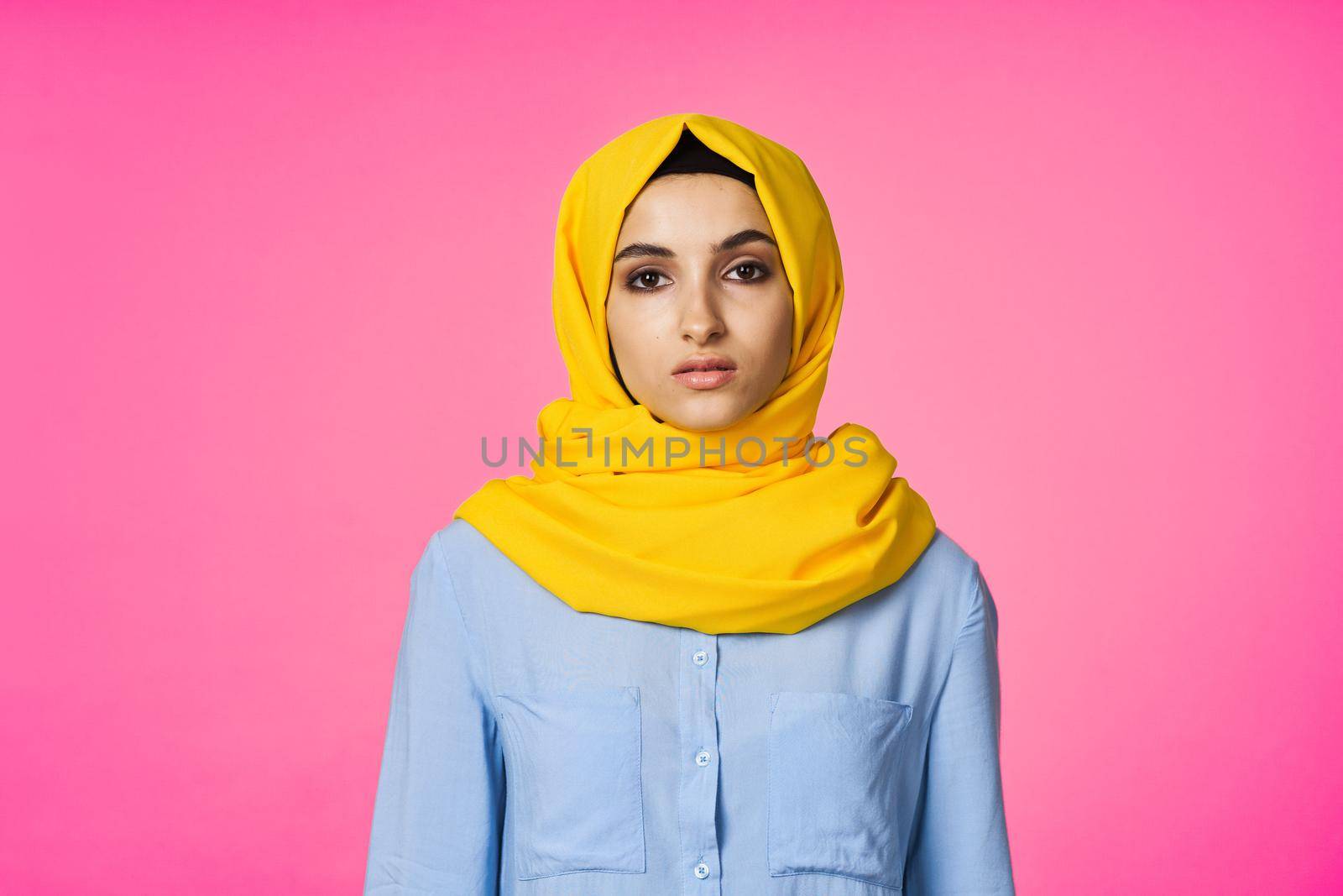 muslim woman in hijab posing fashion ethnicity pink background. High quality photo