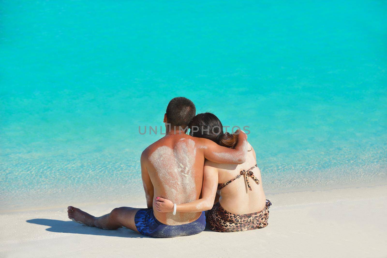 happy young  couple enjoying summer on beach by dotshock