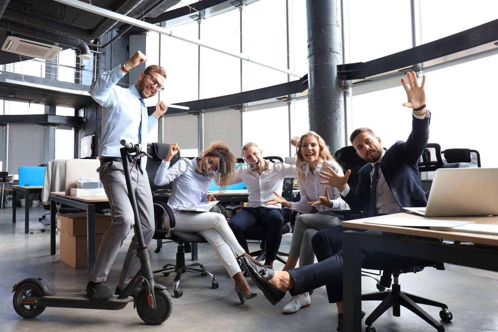 Group of happy progressive business people working on startup together at creative office.