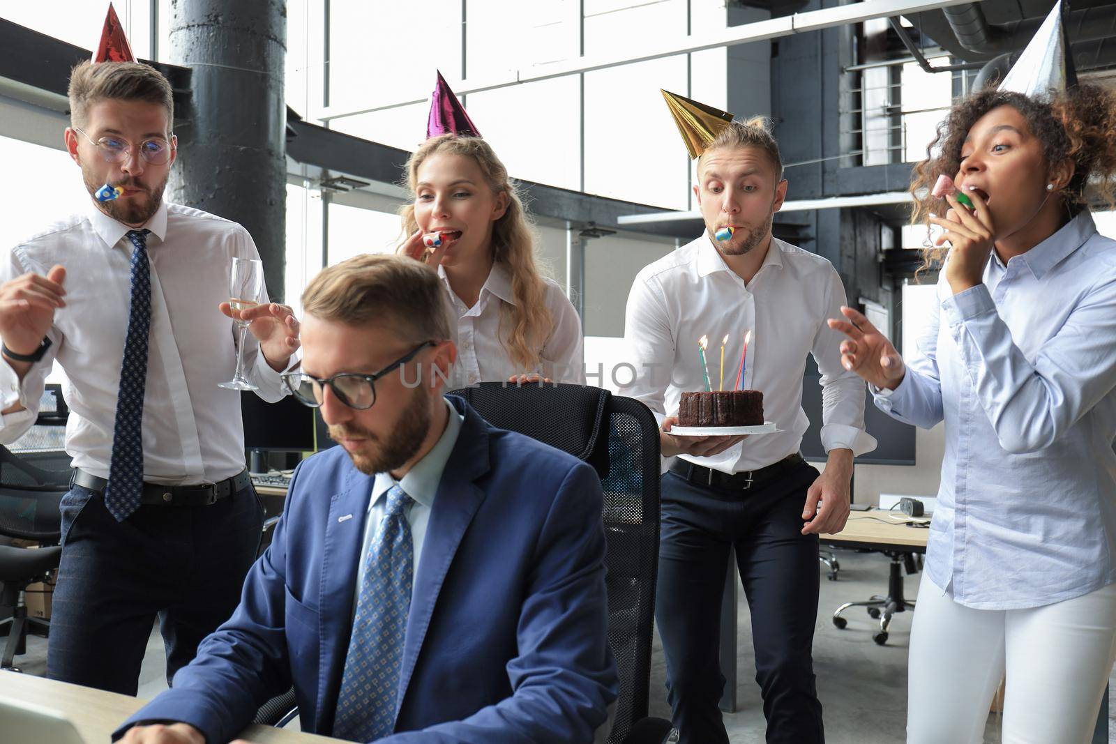 Business team celebrating a birthday of collegue in the modern office.