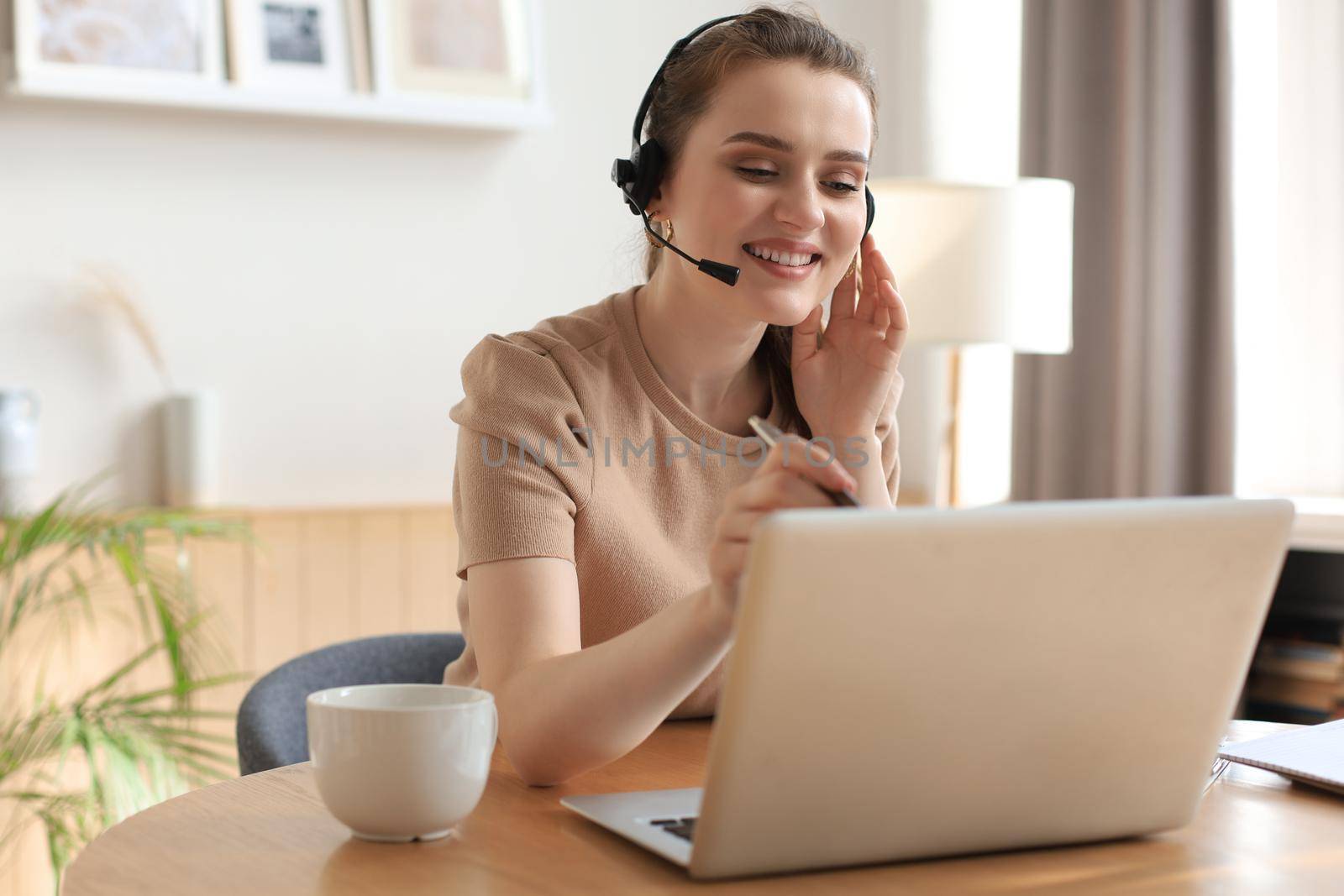 Freelance operator talking with headsets and consulting clients from home office
