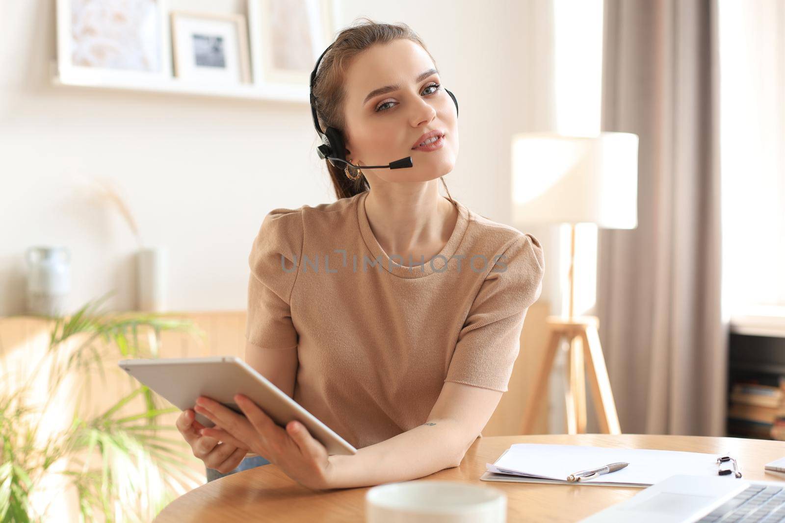 Freelance business women using tablet working call video conference with customer in workplace at home