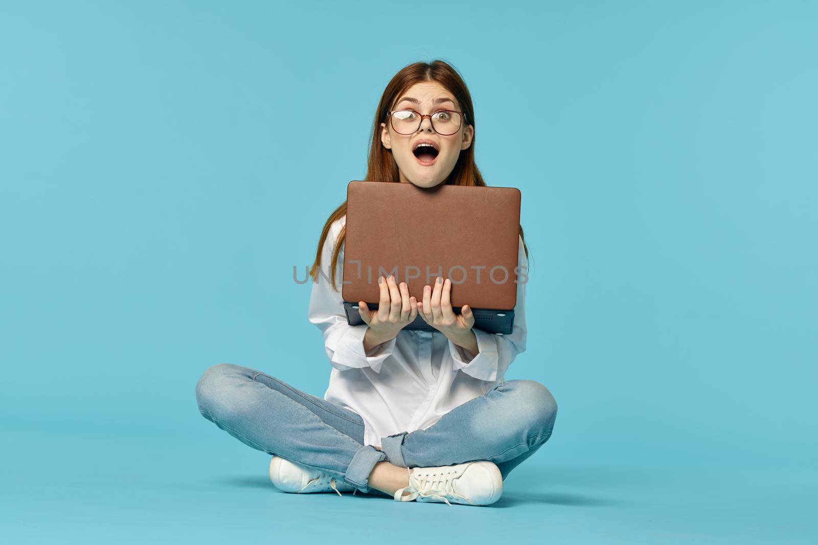 woman sitting on the floor with laptop student education online. High quality photo