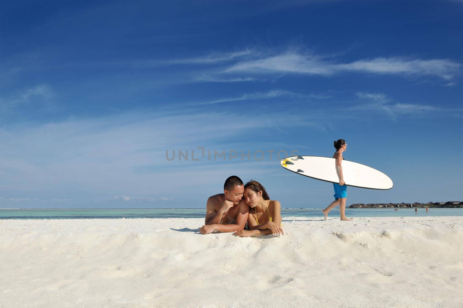 asian couple enjoying summer on beach by dotshock