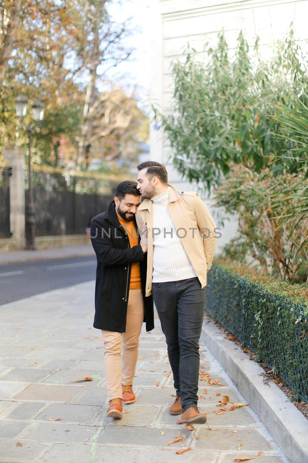 Gays walking, kissing and holding hands in city. Concept of same sex couple and lgbt.