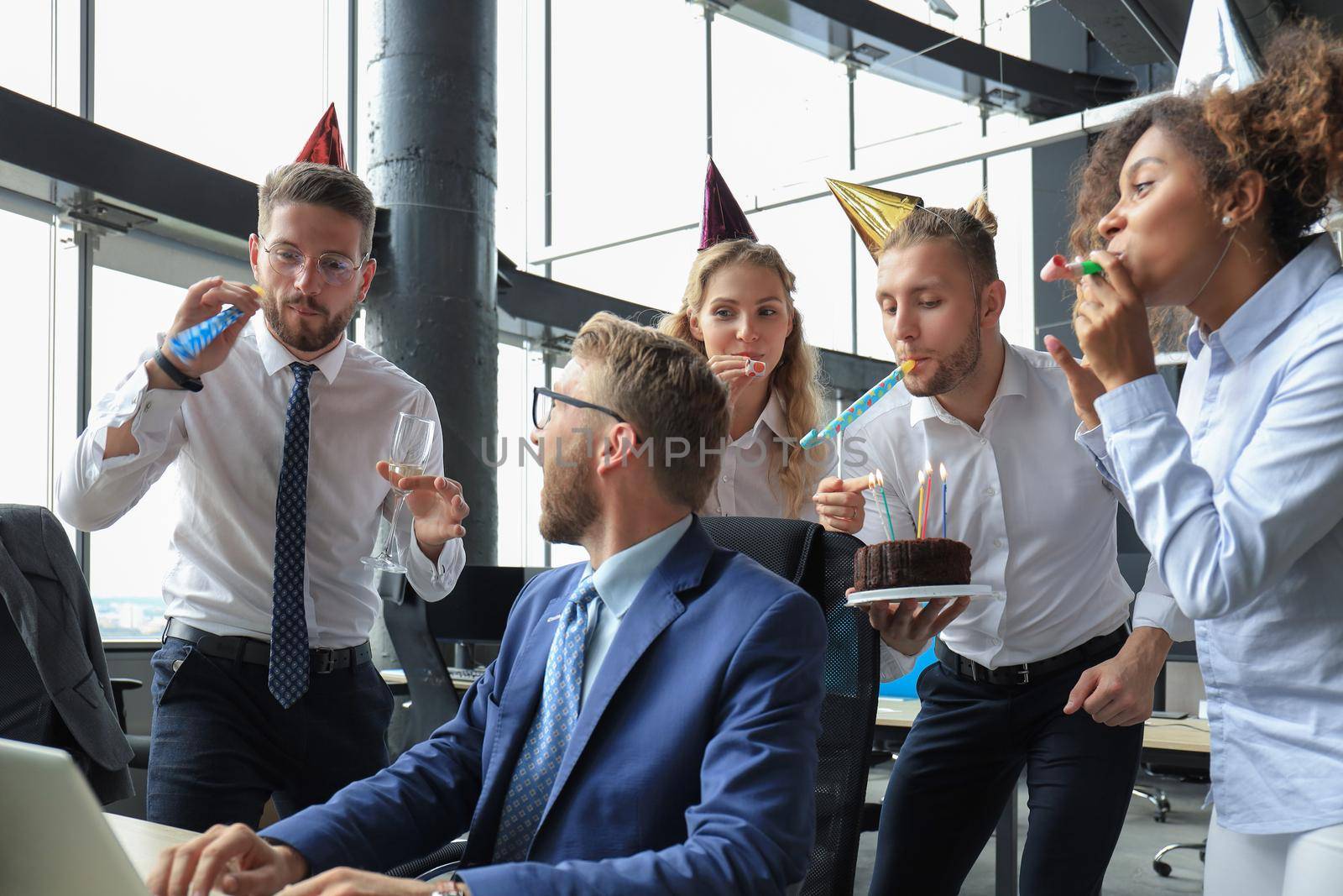 Business team celebrating a birthday of collegue in the modern office.