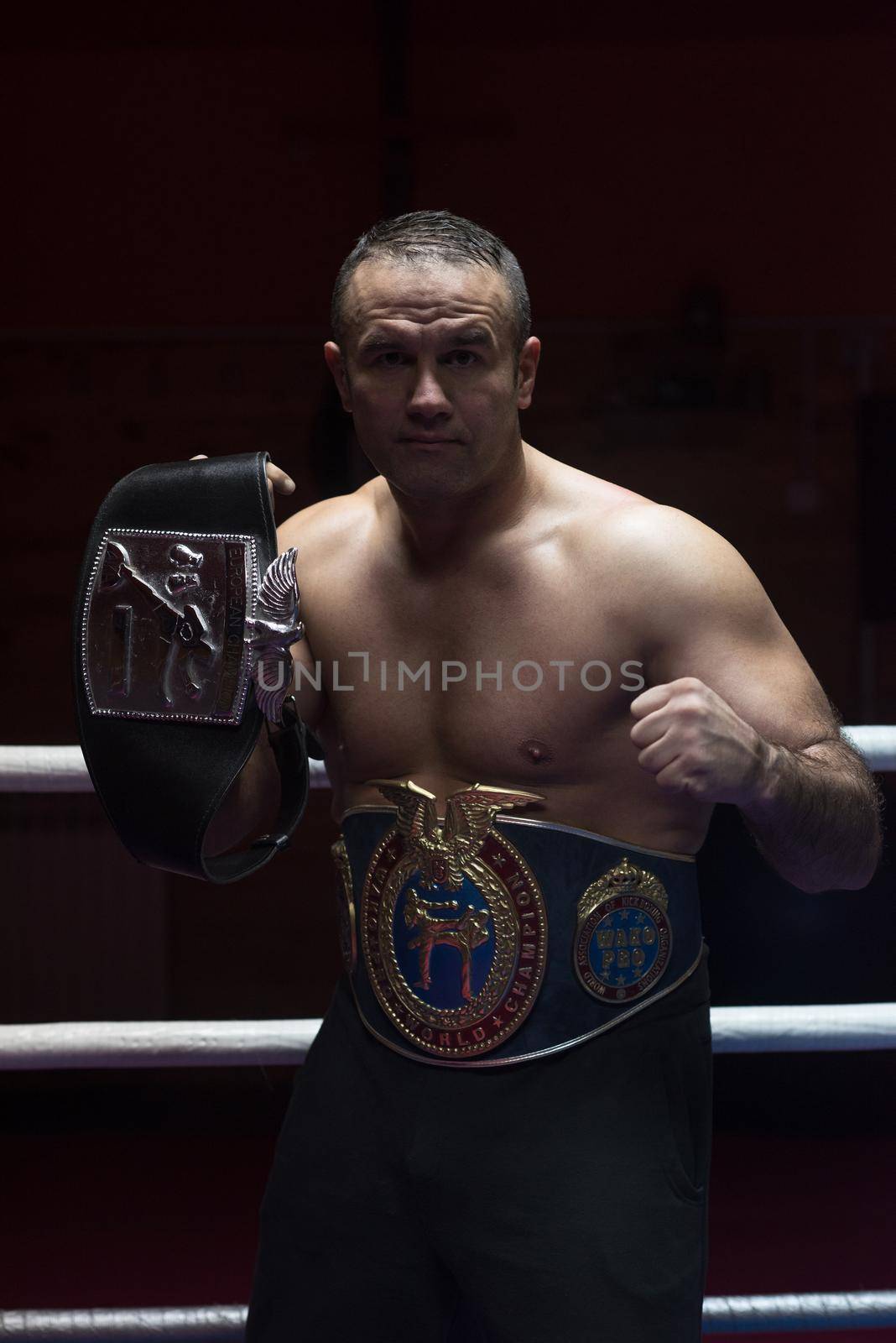 kick boxer with his championship belt by dotshock