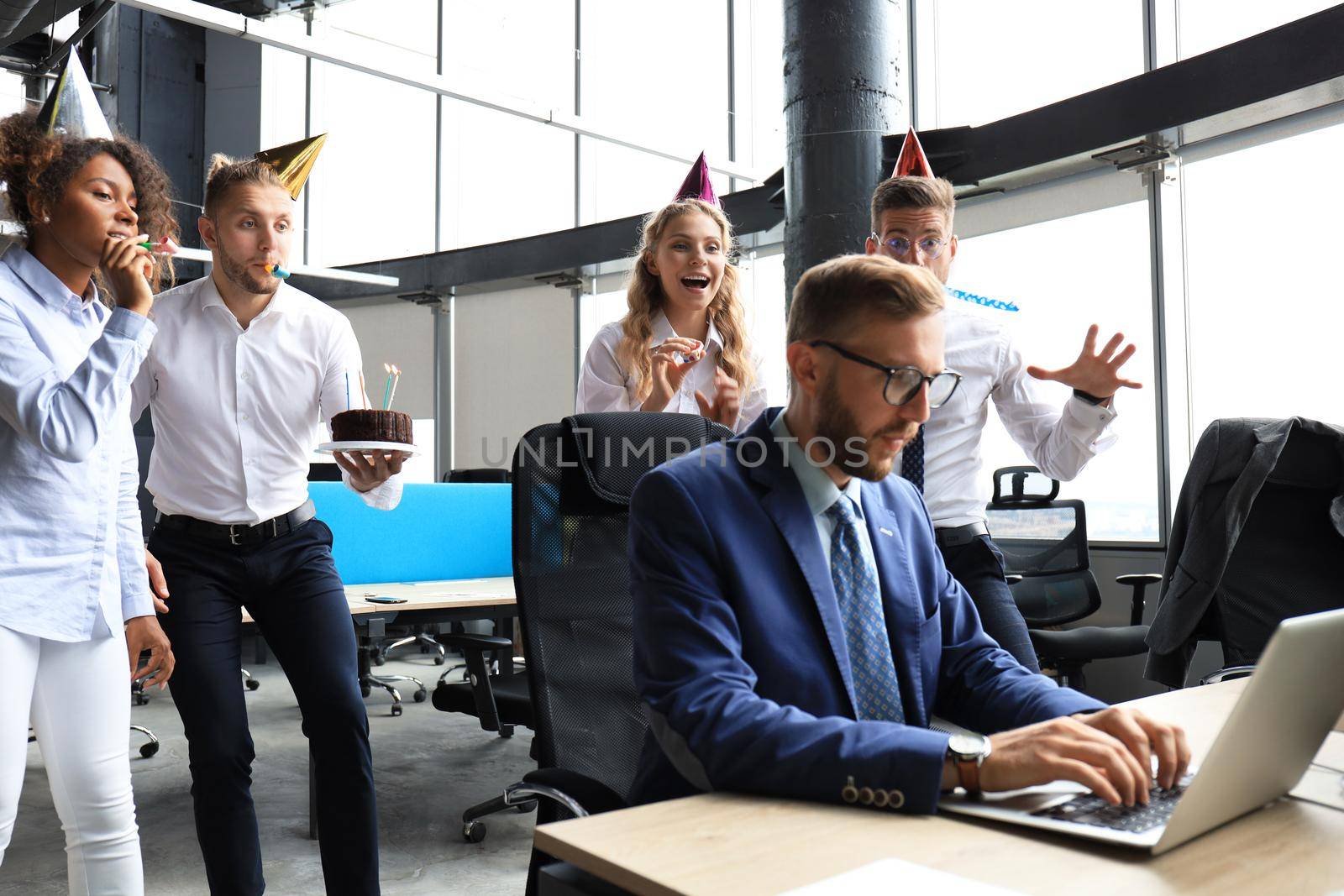 Business team celebrating a birthday of collegue in the modern office.