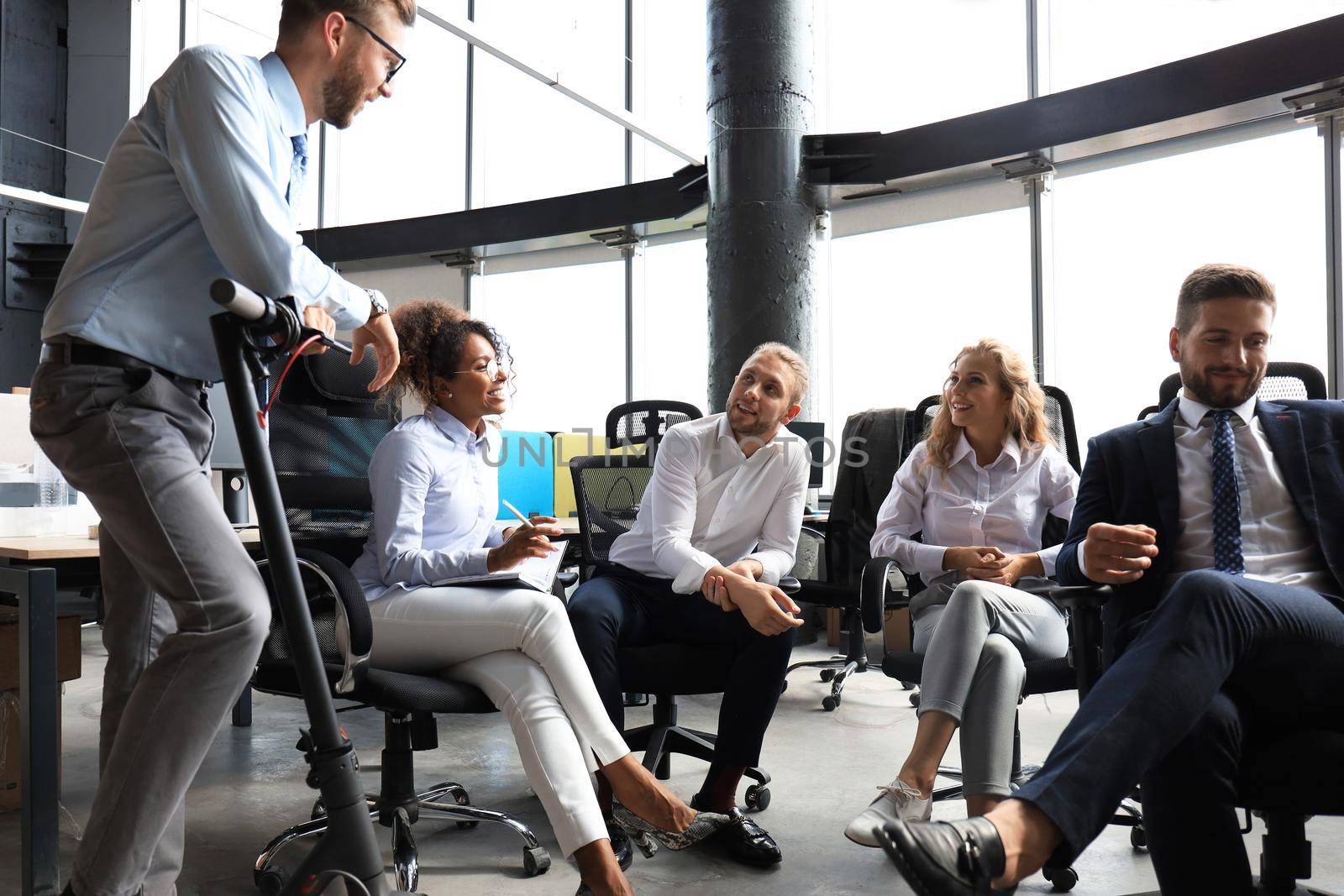 Group of happy progressive business people working on startup together at creative office.