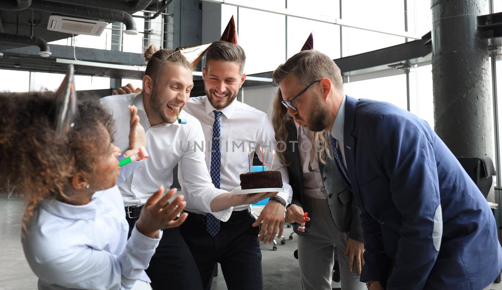 Business team celebrating a birthday of collegue in the modern office.