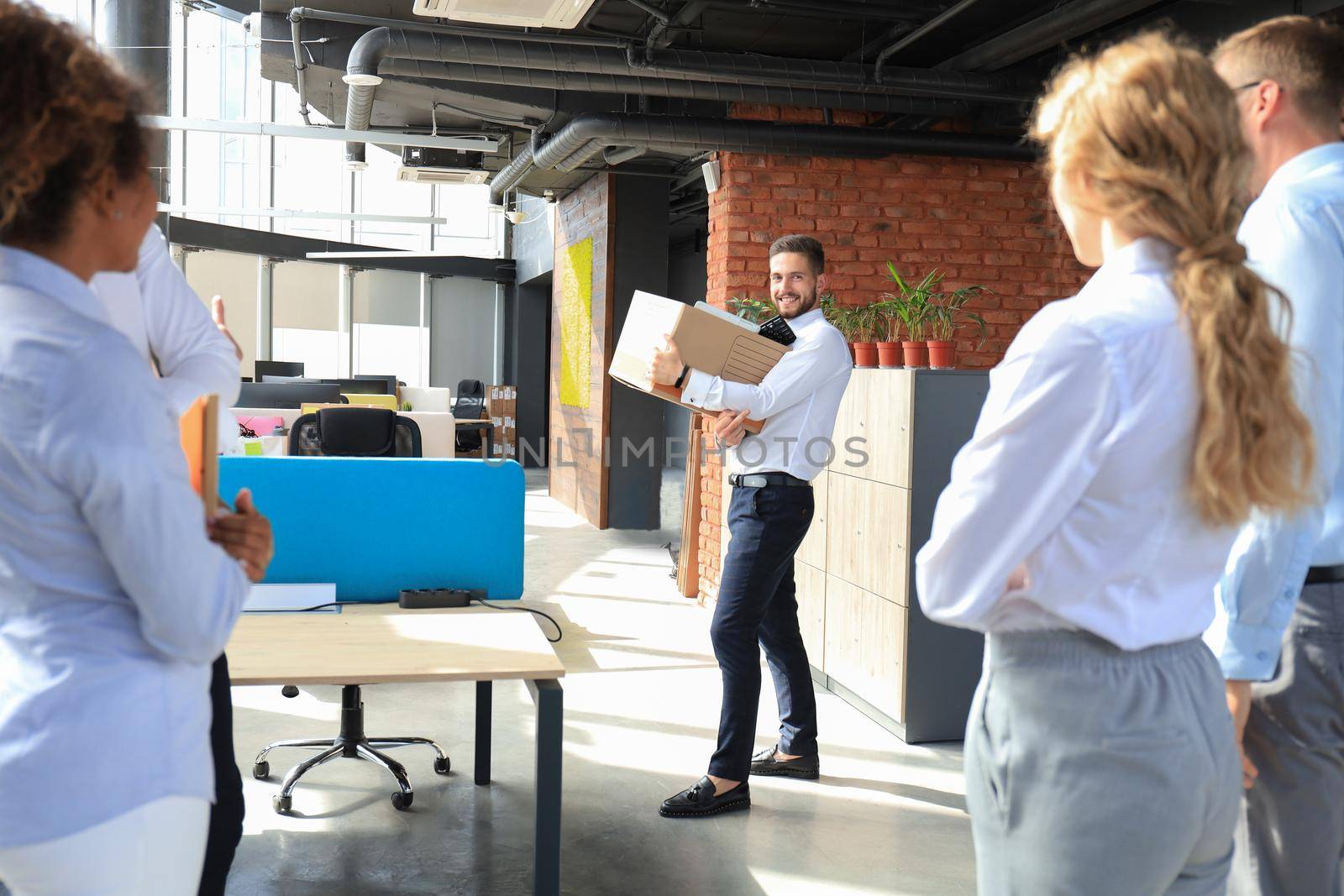 Business colleagues say goodbye to the dismissed employee.