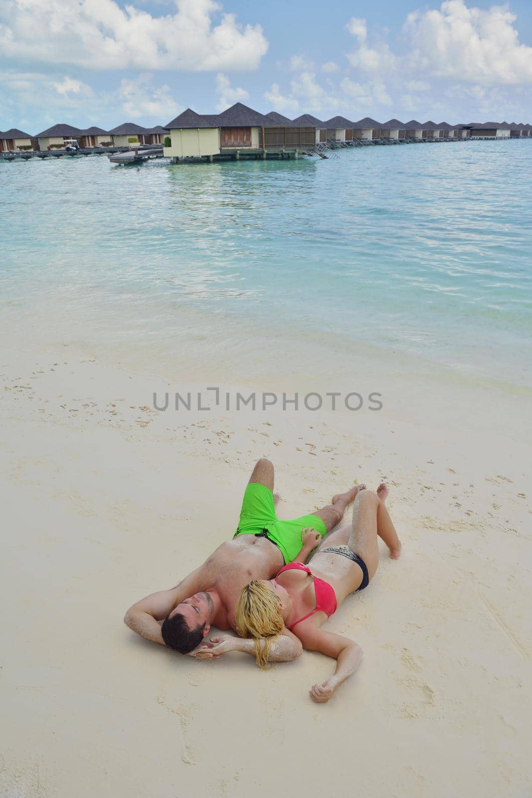 happy young  couple at summer vacation have fun and relax by dotshock