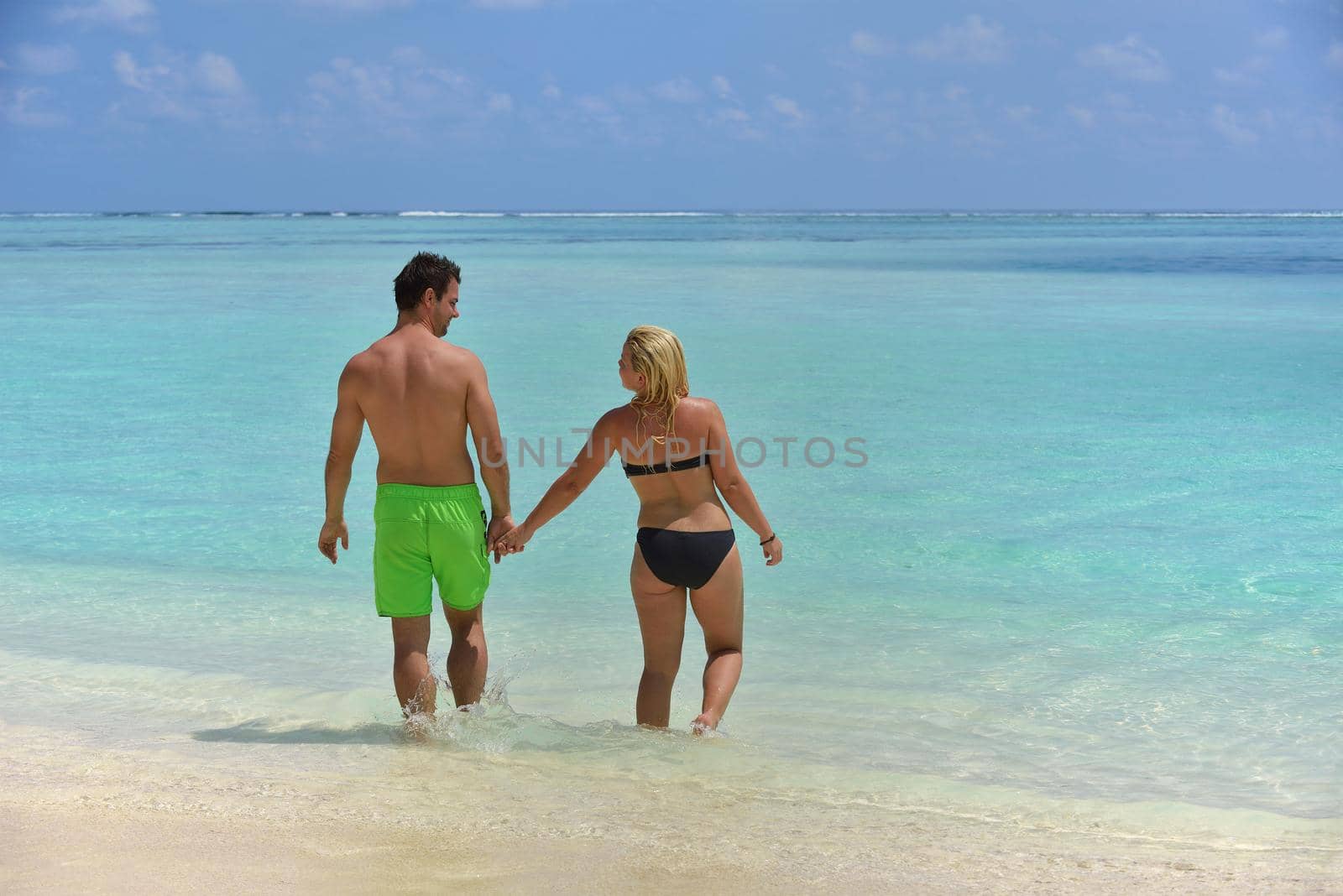 happy young  couple at summer vacation have fun and relax by dotshock