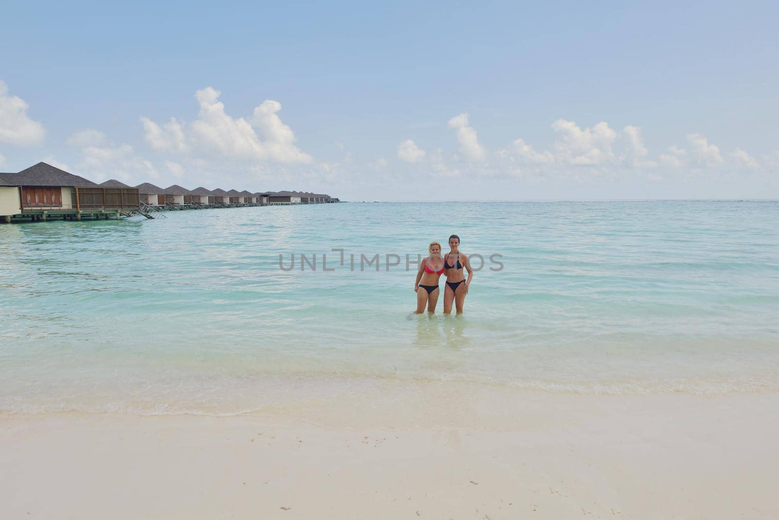 happy young  couple at summer vacation have fun and relax by dotshock