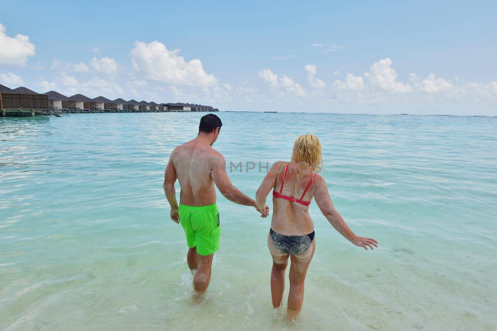 happy young  couple at summer vacation have fun and relax by dotshock