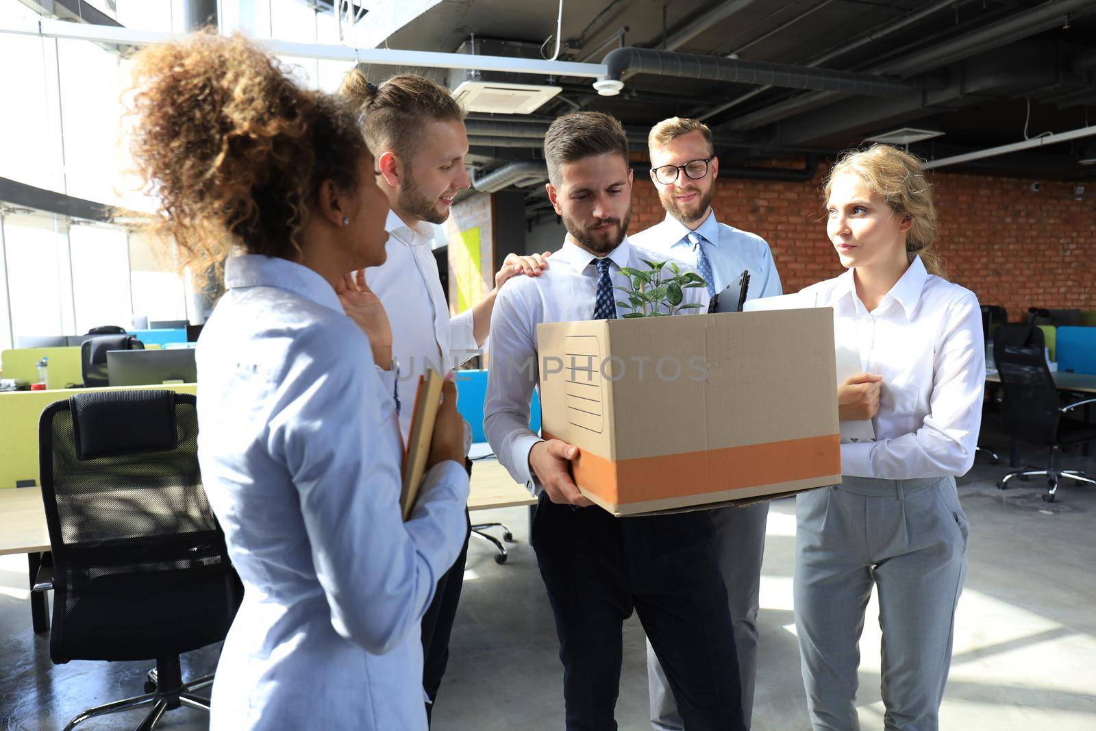 Business colleagues say goodbye to the dismissed employee.