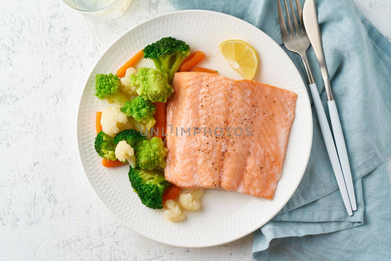 Steam salmon and vegetables, Paleo, keto, fodmap, dash diet. Mediterranean diet with steamed fish. Healthy concept, white plate on gray table, gluten free, lectine free, top view