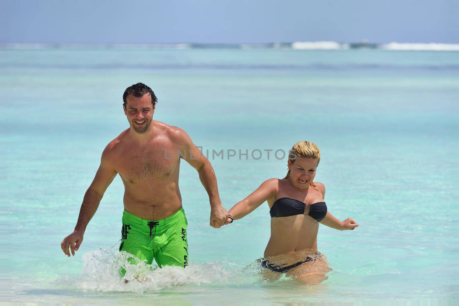 happy young  couple at summer vacation have fun and relax by dotshock