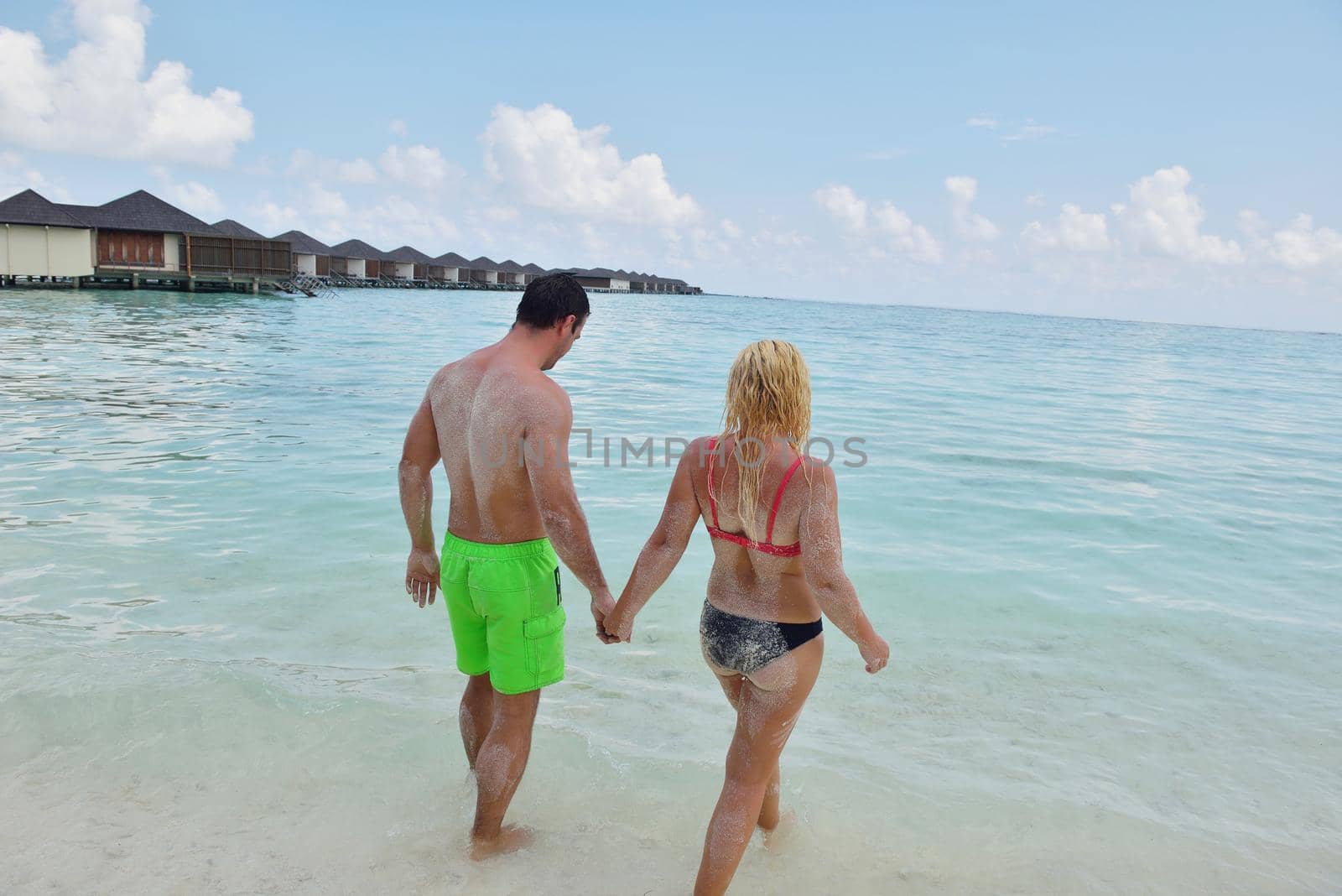 happy young  couple at summer vacation have fun and relax by dotshock