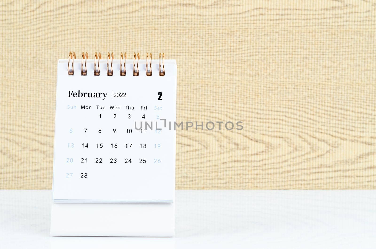 The february 2022 desk calendar on white table.