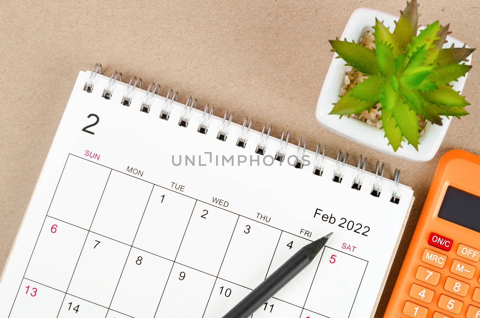 The February 2022 desk calendar with calculator.