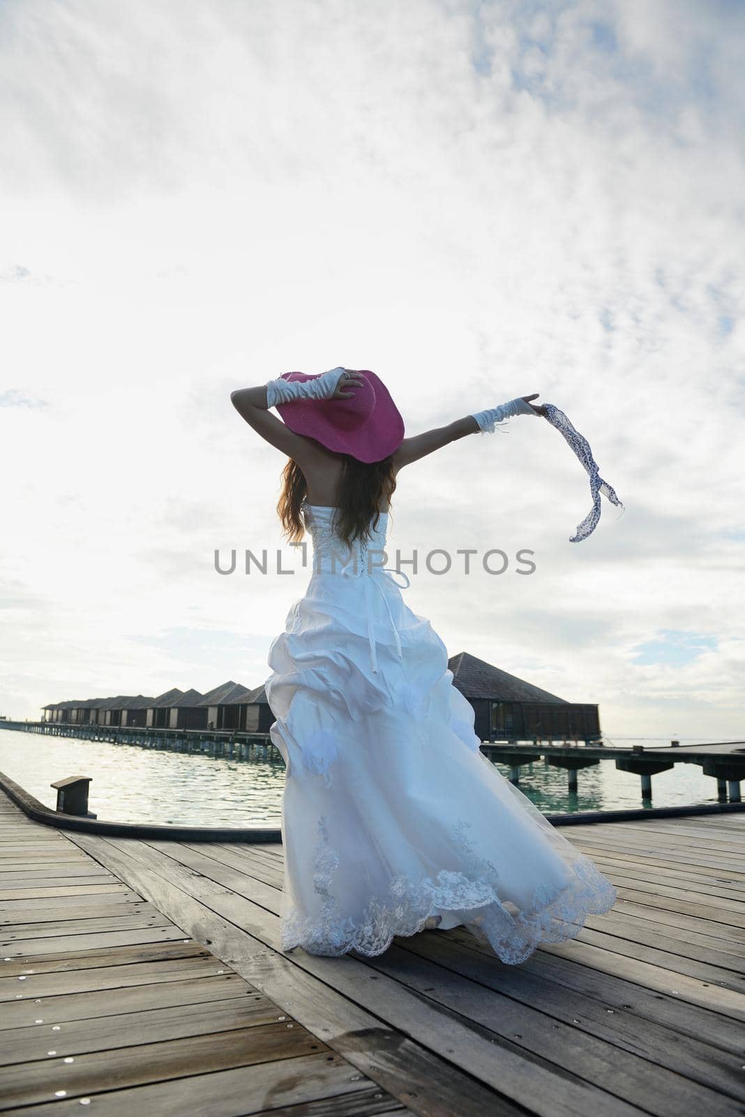 asian  bride with a veil on the beach in the sky and blue sea. honeymoon on the fantastic island at summer