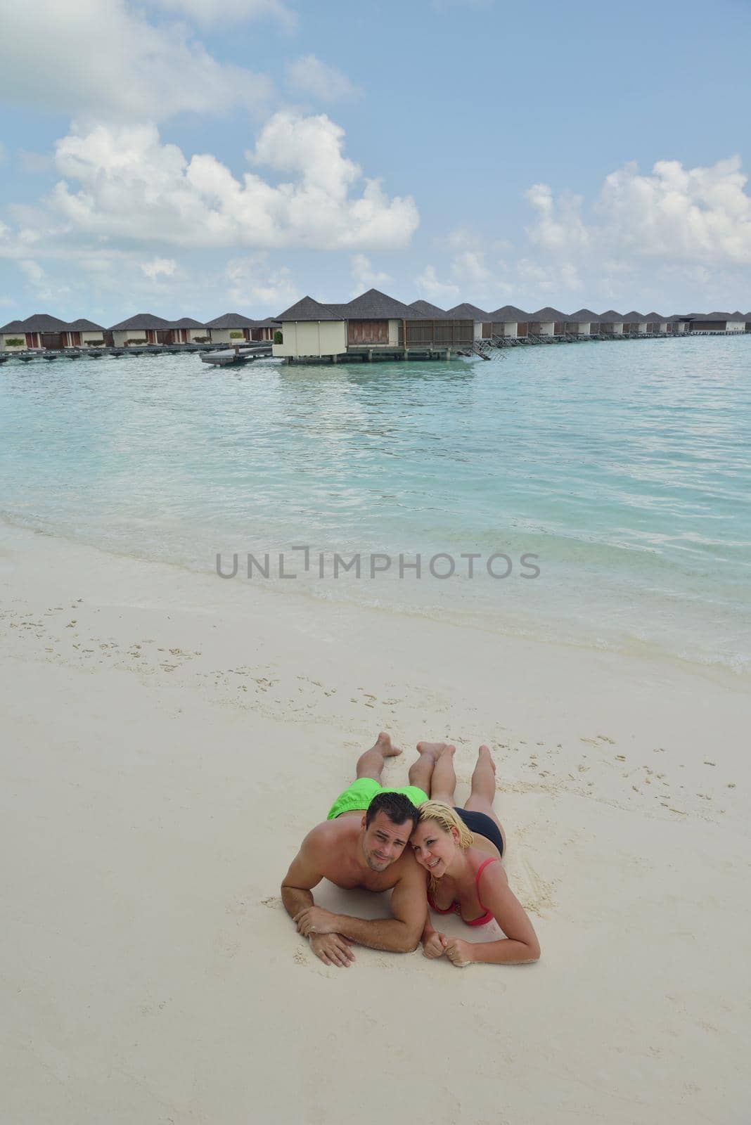 happy young  couple at summer vacation have fun and relax at beautiful sunny  day on beach