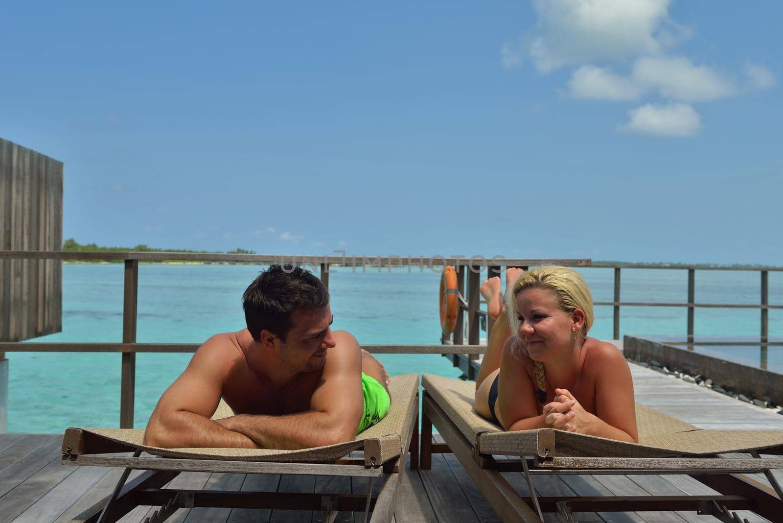 happy young  couple at summer vacation have fun and relax at beautiful sunny  day on beach