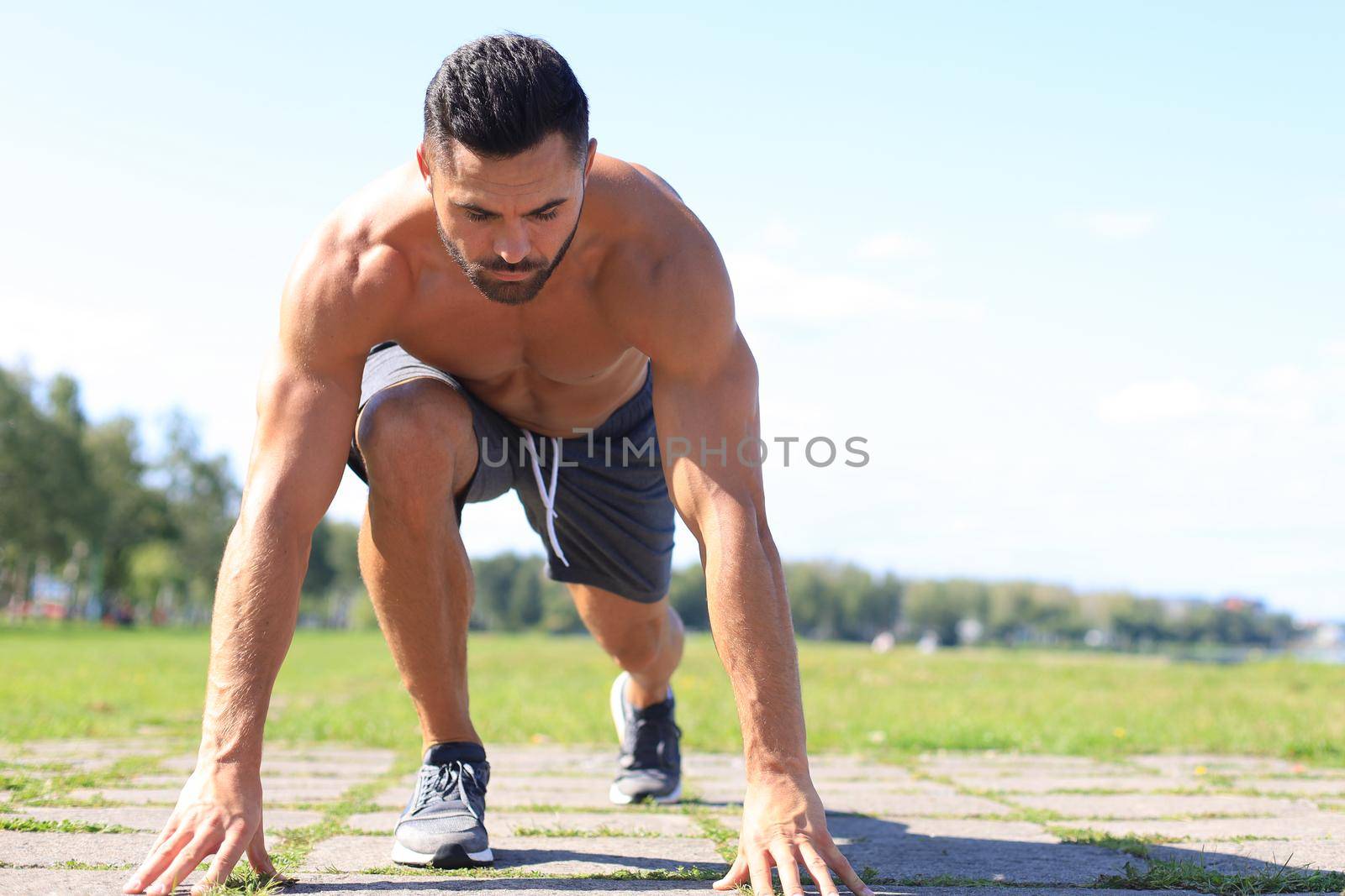 Athletic young man running in the nature. Concept of healthy lifestyle