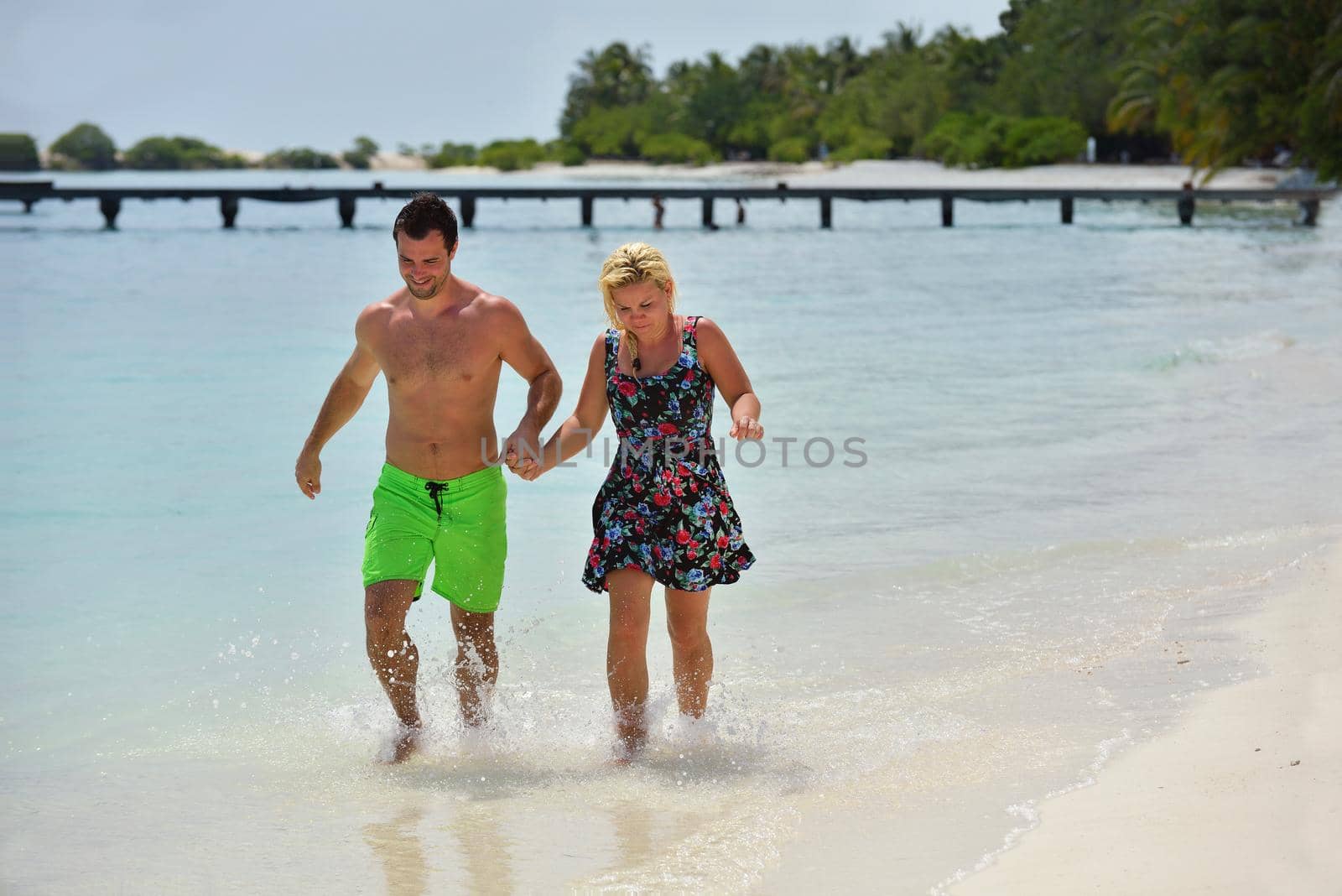 happy young  couple at summer vacation have fun and relax at beach by dotshock