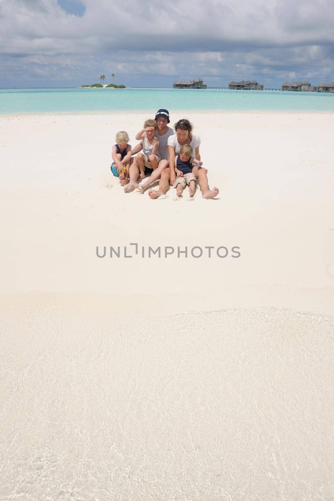 Portrait of a happy family on summer vacation  at beach