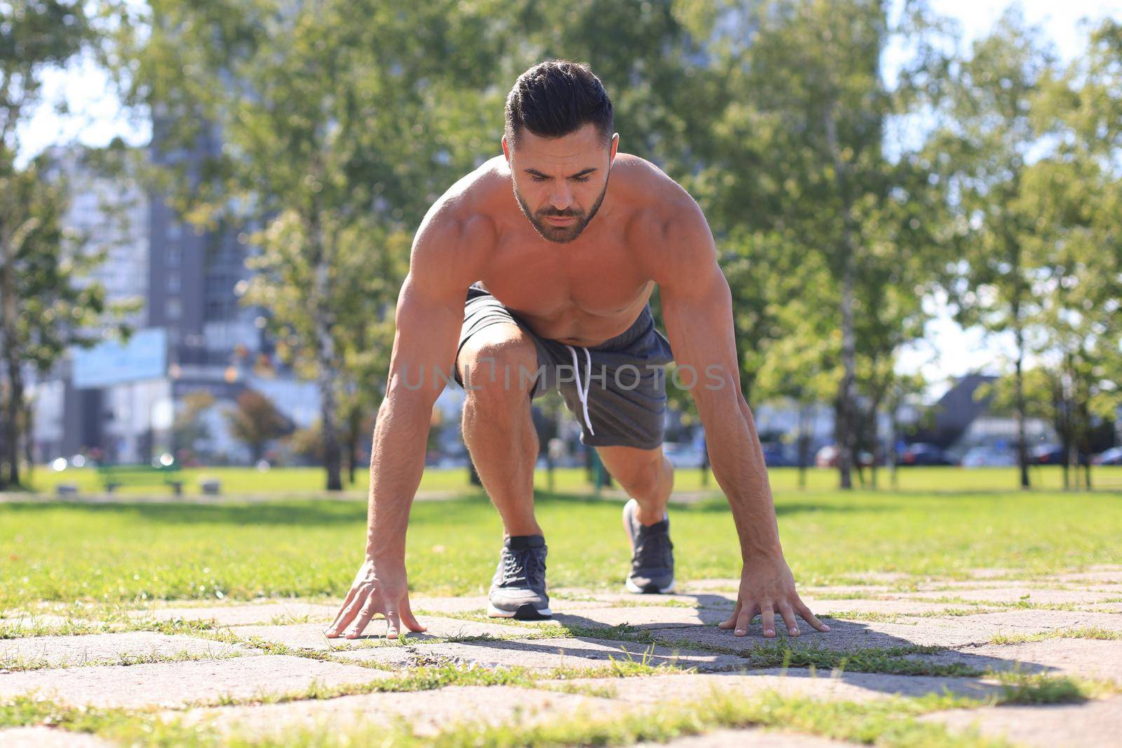 Athletic young man running in the nature. Concept of healthy lifestyle