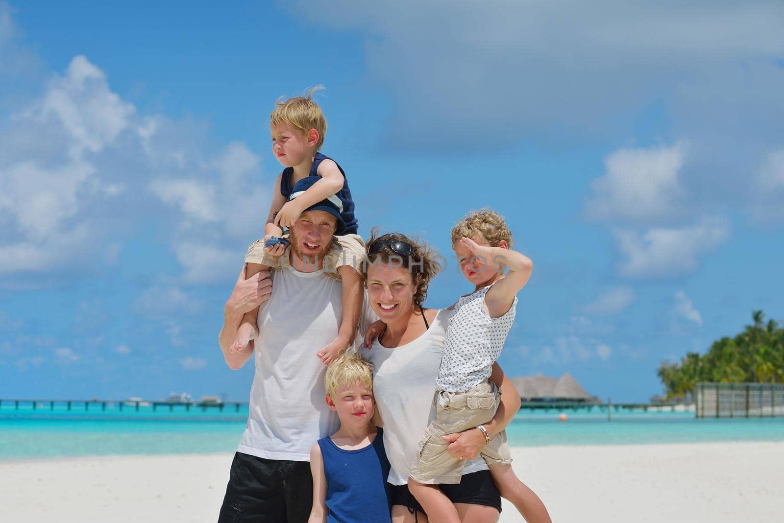 Portrait of a happy family on summer vacation  at beach