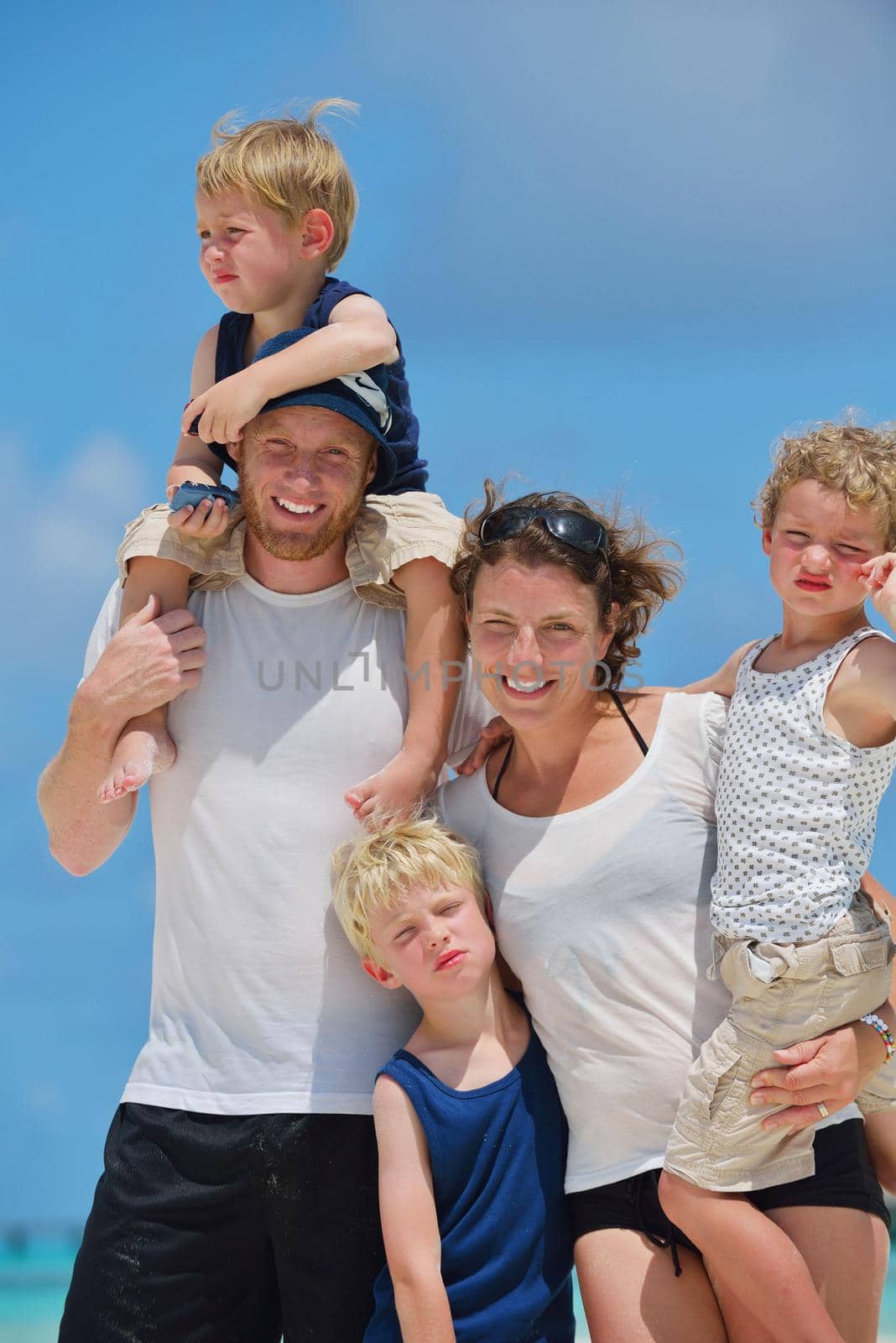 Portrait of a happy family on summer vacation  at beach
