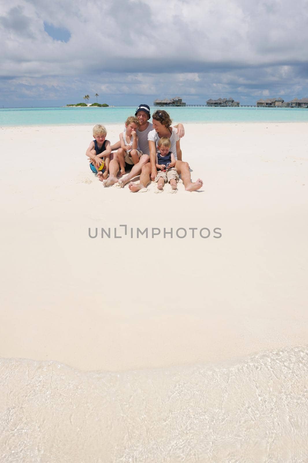 Portrait of a happy family on summer vacation  at beach