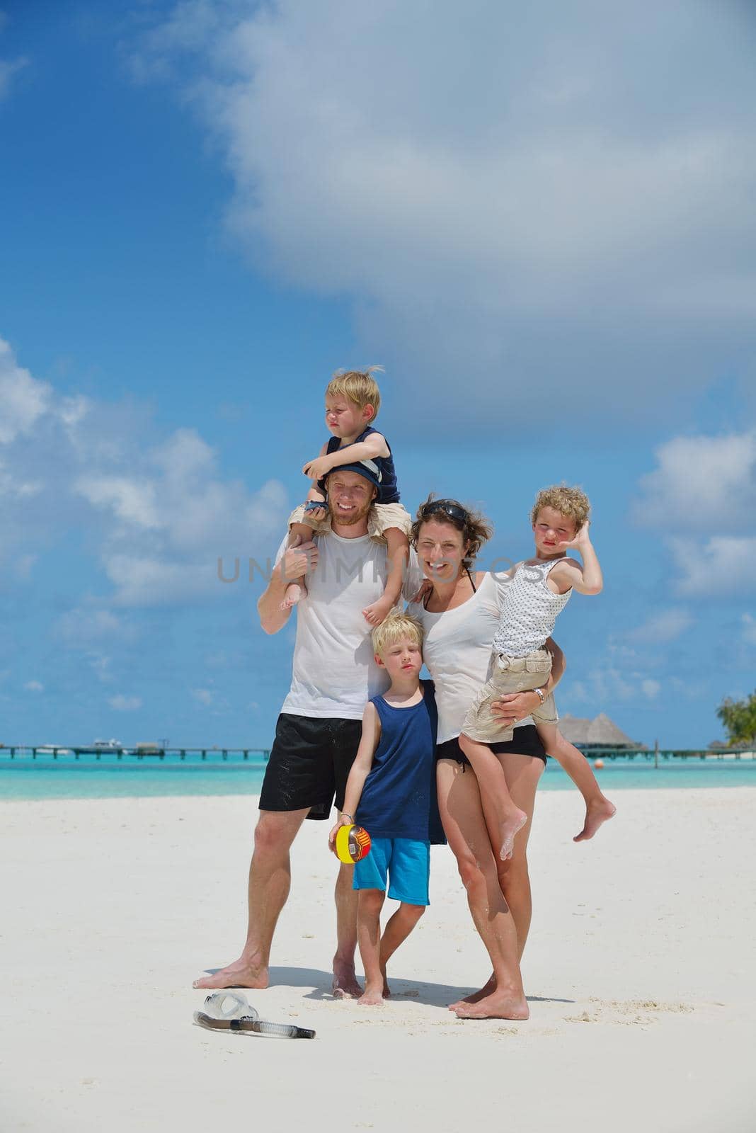 Portrait of a happy family on summer vacation  at beach