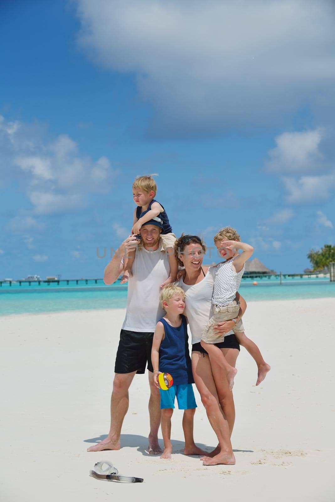 Portrait of a happy family on summer vacation  at beach