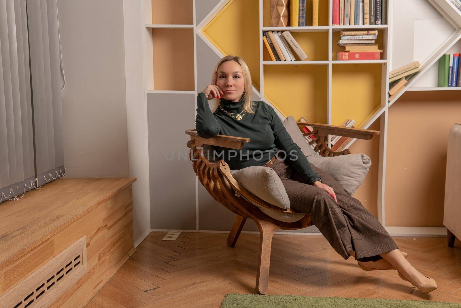 Woman sits on a chair girl business internet, technology beauty attractive happy, positive work. Posing feminine color, style joyful