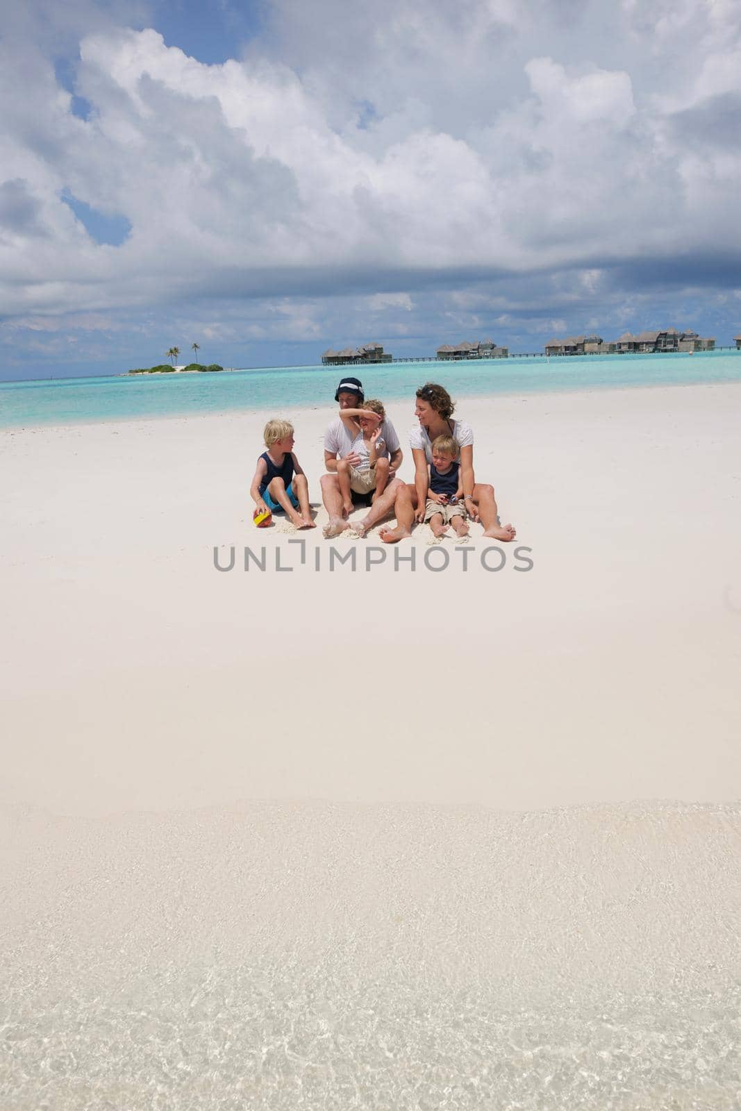 Portrait of a happy family on summer vacation  at beach