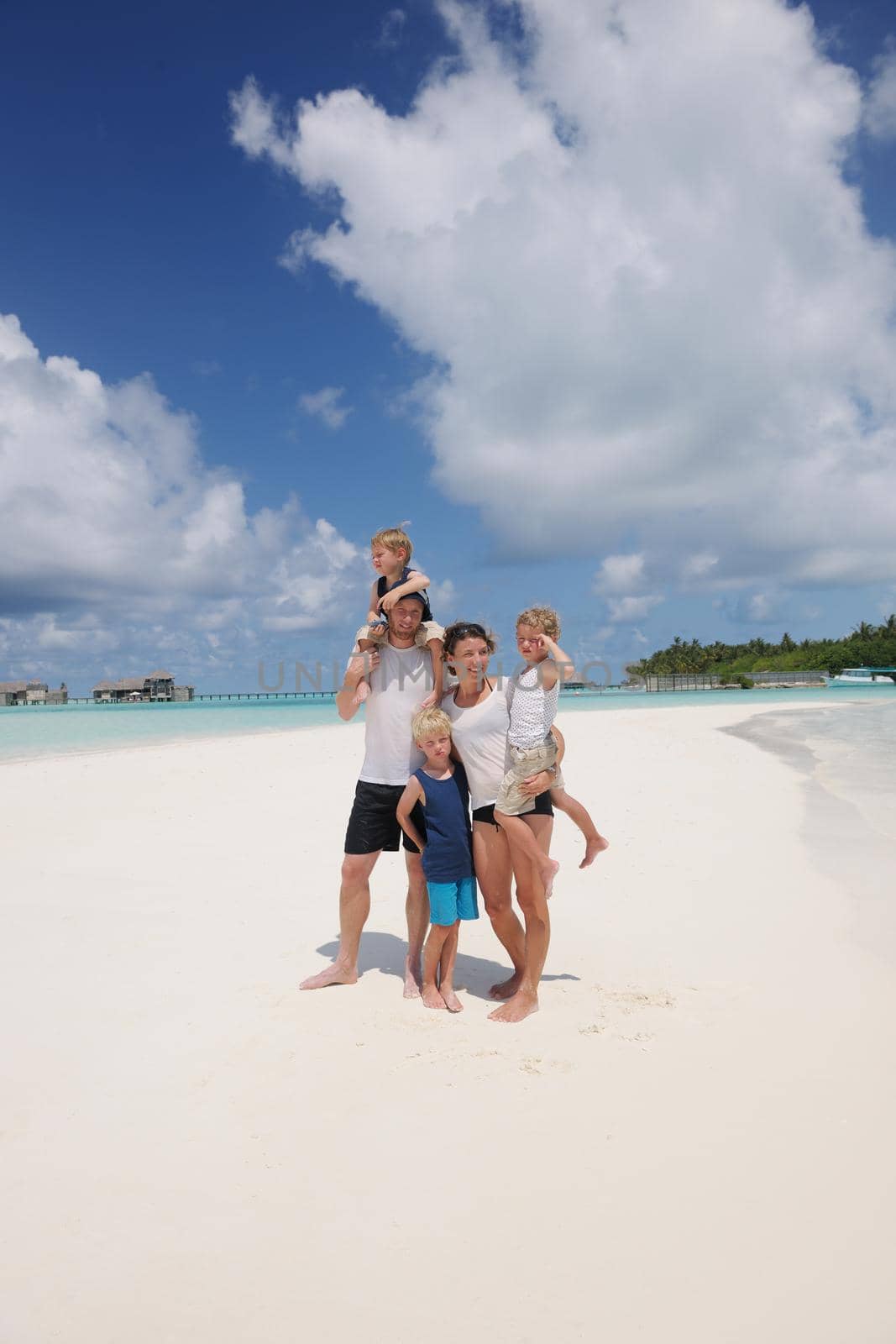 Portrait of a happy family on summer vacation  at beach