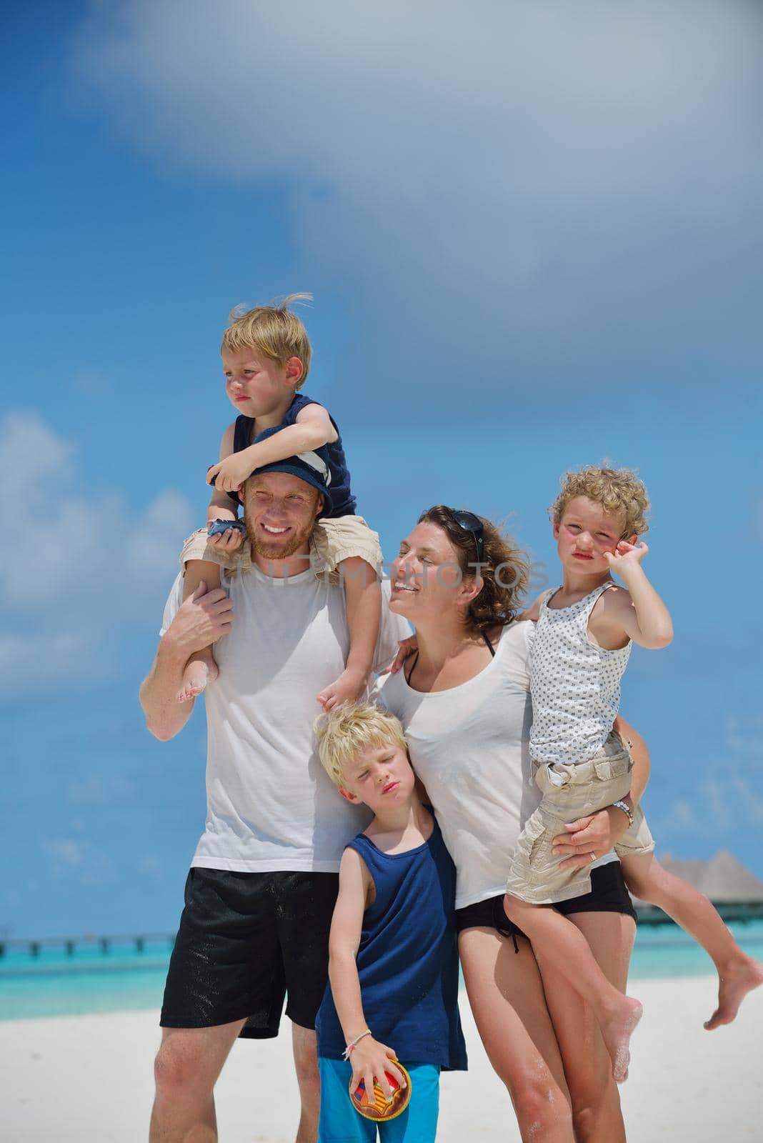 Portrait of a happy family on summer vacation  at beach